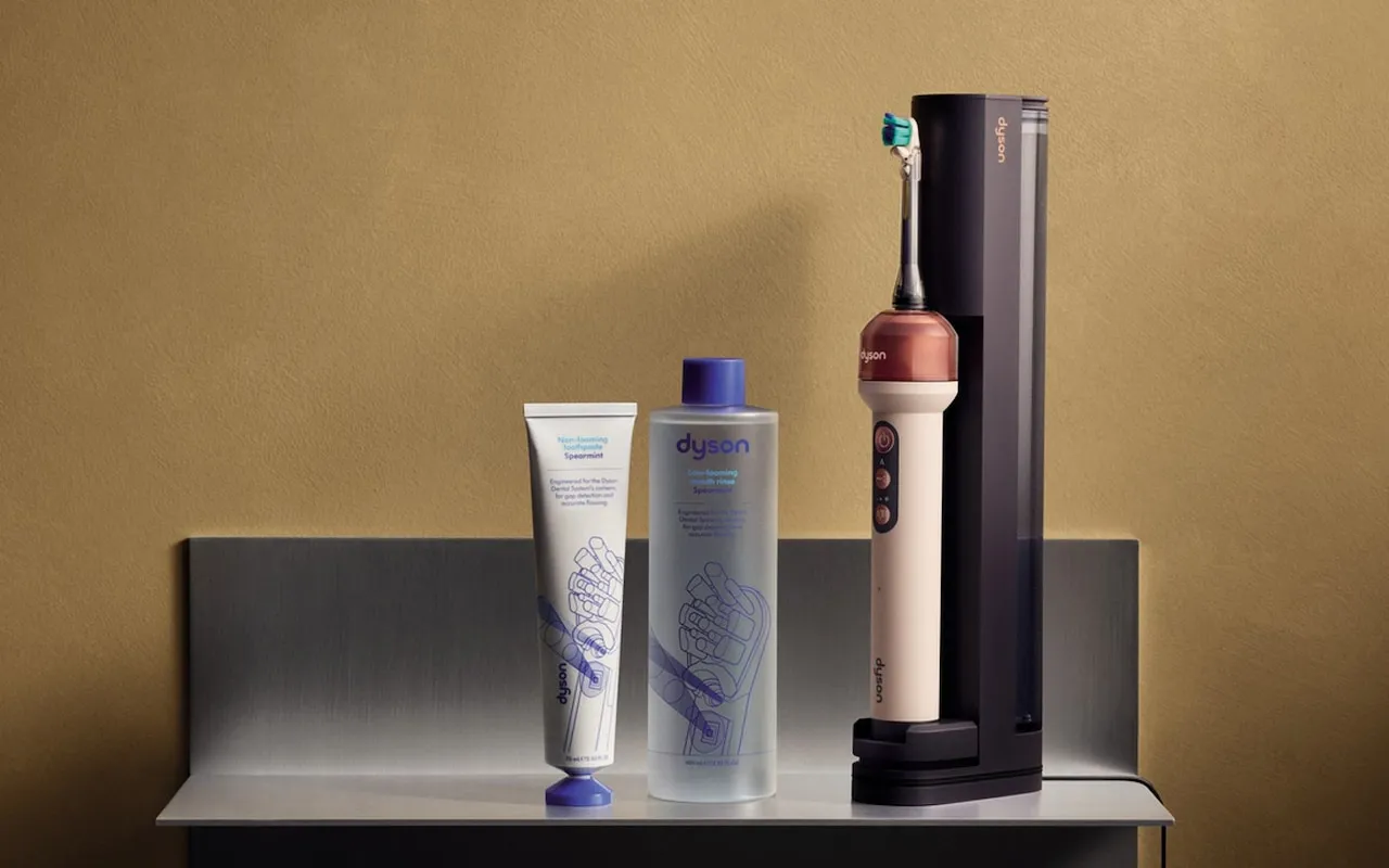 Dyson's toothpaste tube and mouthrinse bottle beside the CameraJet in its dark docking station